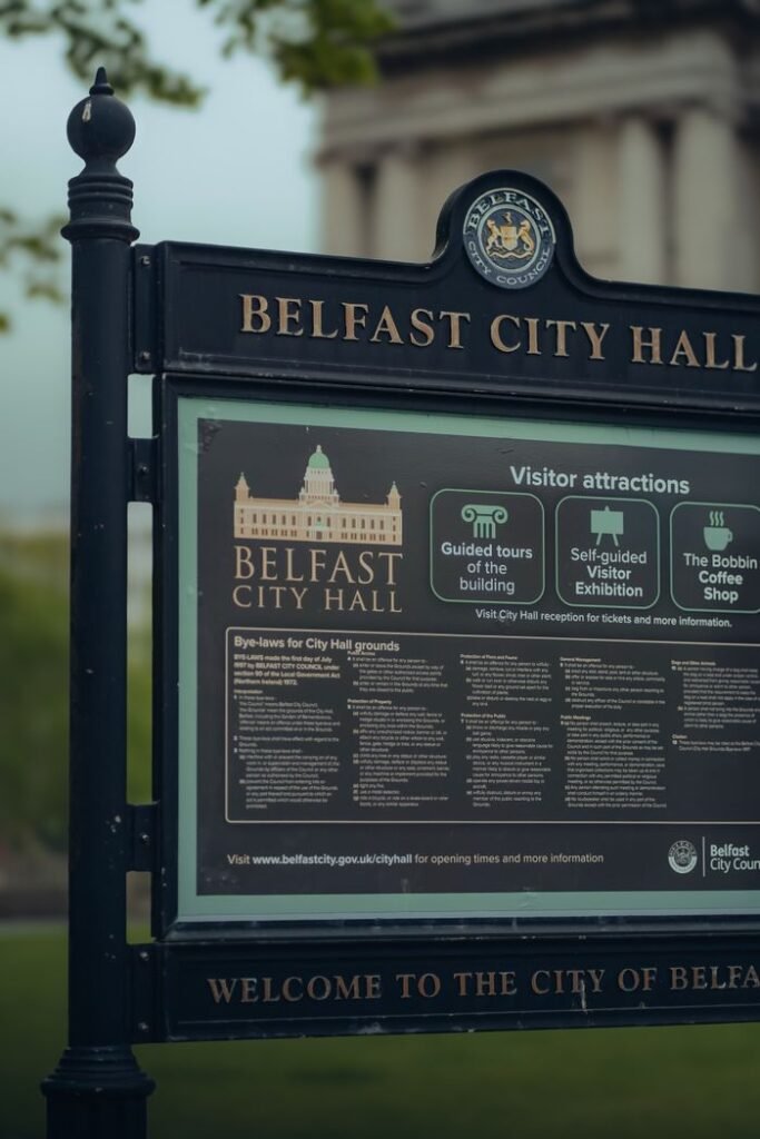 Signage for Belfast City Hall with visitor information, located in Belfast, Northern Ireland.